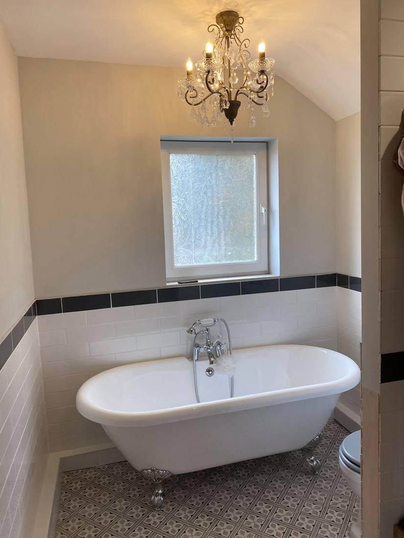 Freestanding bath with chandelier, period home renovation
