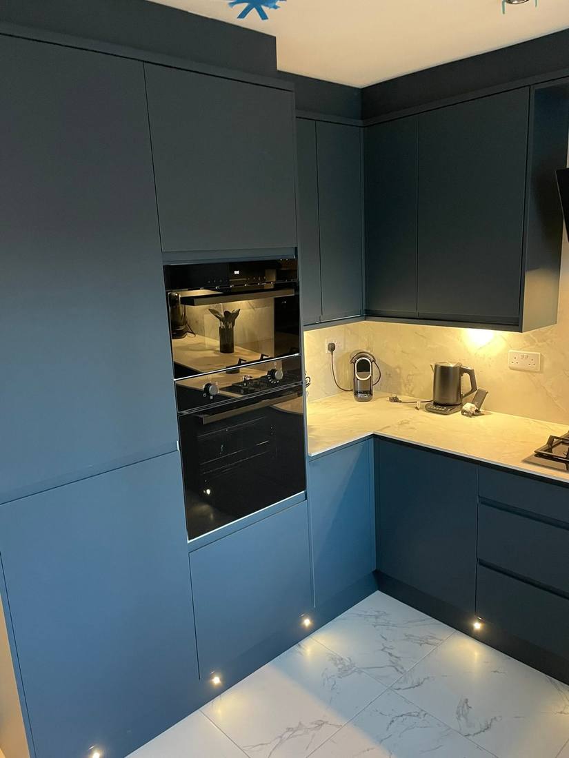 Navy blue kitchen with integrated double ovens