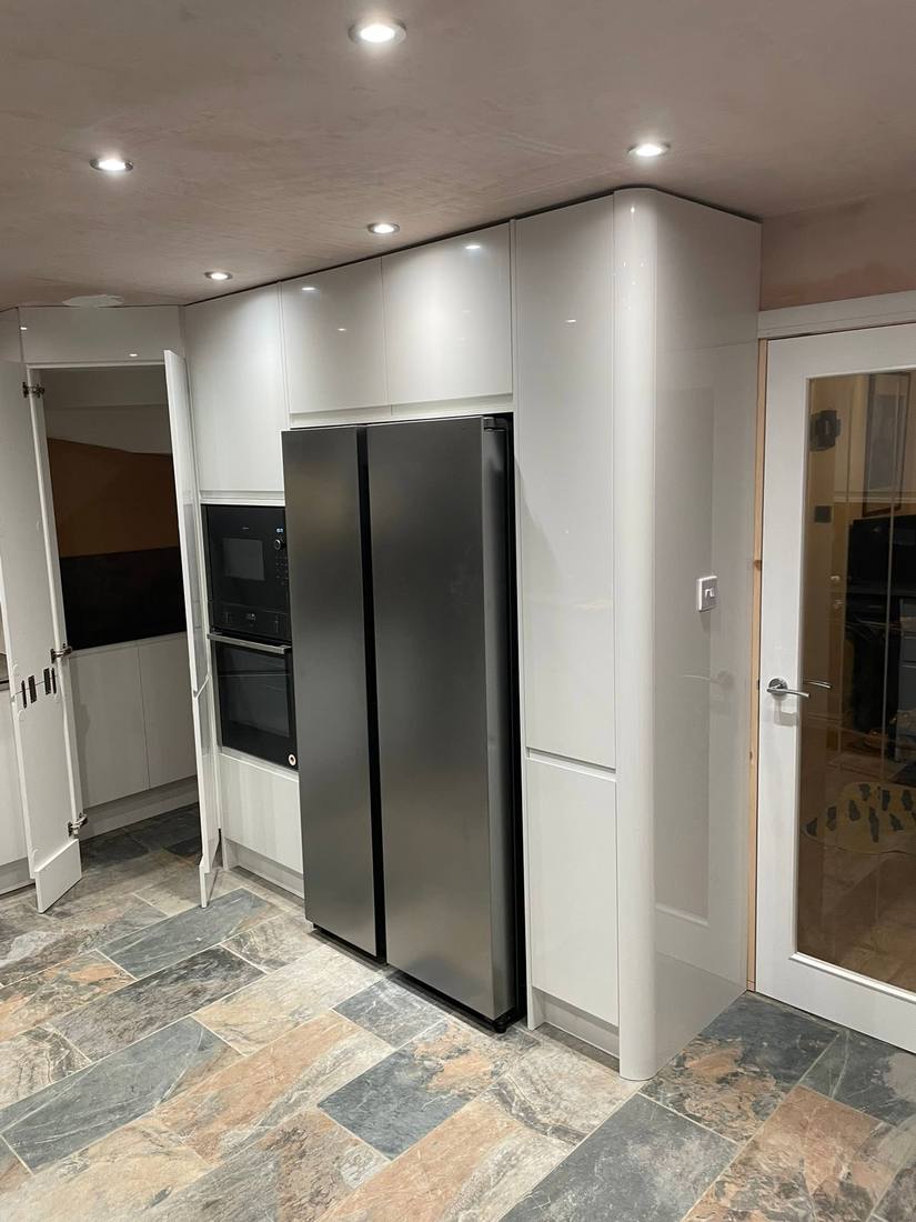 Gloss white cabinetry with integrated appliance housing